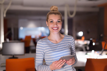 Image showing woman working on digital tablet in night office