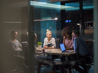 Image showing Multiethnic startup business team in night office