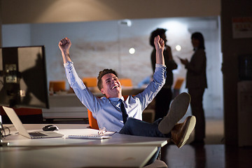 Image showing businessman sitting with legs on desk at office