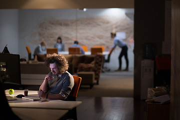 Image showing Tired businessman working late