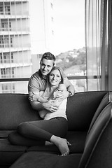 Image showing young handsome couple hugging on the sofa