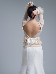 Image showing Rear view of a beautiful young woman in a wedding dress