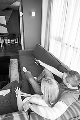 Image showing Young couple on the sofa watching television