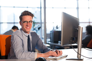 Image showing businessman working using a computer in startup office