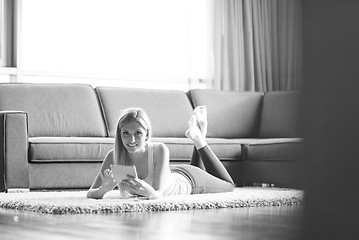 Image showing young women using tablet computer on the floor