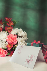 Image showing Love background with pink roses, flowers, gift on table