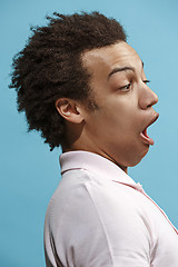 Image showing The young attractive man looking suprised isolated on blue