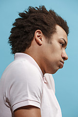 Image showing Beautiful bored afro man isolated on blue background