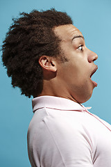 Image showing The young attractive man looking suprised isolated on blue