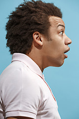 Image showing The young attractive man looking suprised isolated on blue