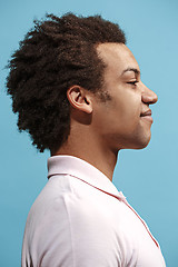 Image showing The happy business man standing and smiling against blue background.