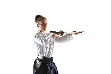 Image showing Aikido master practices defense posture. Healthy lifestyle and sports concept. Woman in white kimono on white background.