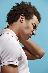 Image showing Young man overwhelmed with a pain in the necks