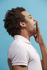 Image showing Beautiful bored afro man isolated on blue background