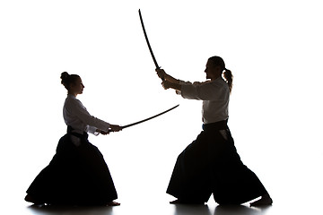 Image showing Man and woman fighting and training aikido on white studio background