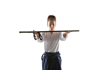 Image showing Aikido master practices defense posture. Healthy lifestyle and sports concept. Woman in white kimono on white background.