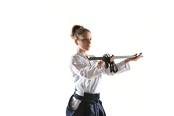 Image showing Aikido master practices defense posture. Healthy lifestyle and sports concept. Woman in white kimono on white background.