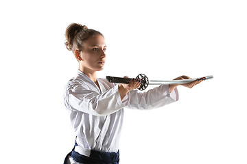 Image showing Aikido master practices defense posture. Healthy lifestyle and sports concept. Woman in white kimono on white background.