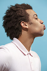 Image showing Portrait of attractive afro man with kiss isolated over blue background