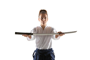 Image showing Aikido master practices defense posture. Healthy lifestyle and sports concept. Woman in white kimono on white background.