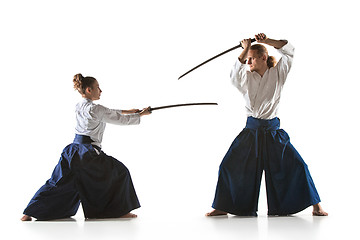 Image showing Man and woman fighting and training aikido on white studio background