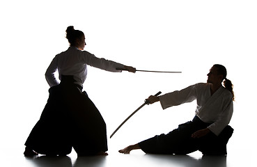 Image showing Man and woman fighting and training aikido on white studio background