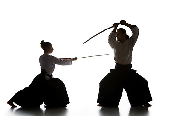 Image showing Man and woman fighting and training aikido on white studio background