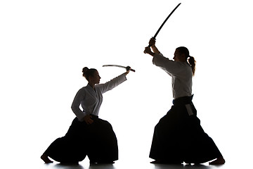 Image showing Man and woman fighting and training aikido on white studio background