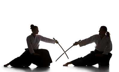 Image showing Man and woman fighting and training aikido on white studio background