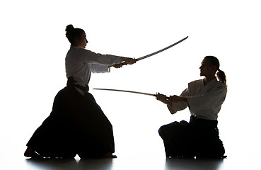 Image showing Man and woman fighting and training aikido on white studio background