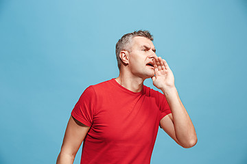 Image showing Isolated on pink young casual man shouting at studio