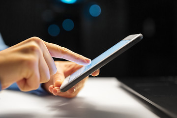 Image showing close up of hands with smartphone at night office