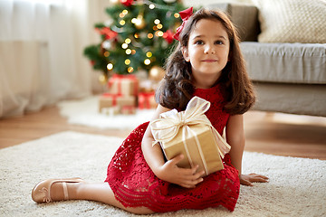 Image showing happy girl with christmas gift at home