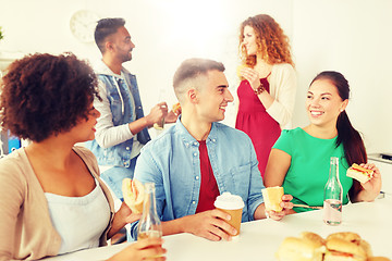 Image showing happy friends or team eating at office