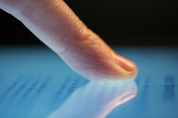 Image showing close up of hand using computer touch screen