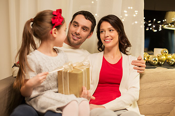 Image showing happy family with christmas present at home