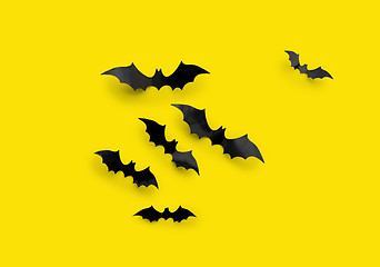 Image showing black halloween bats on yellow background