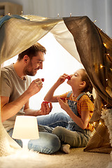 Image showing family playing tea party in kids tent at home