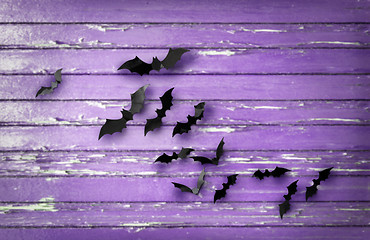 Image showing black bats over ultra violet shabby boards