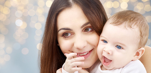 Image showing mother with baby over festive lights background
