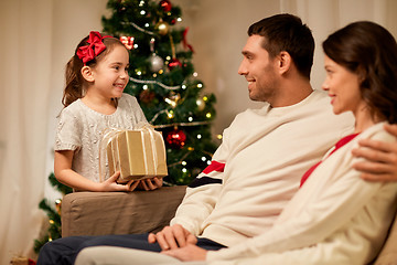 Image showing happy family with christmas present at home