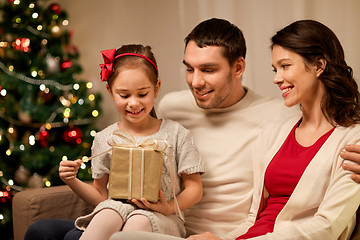 Image showing happy family with christmas present at home