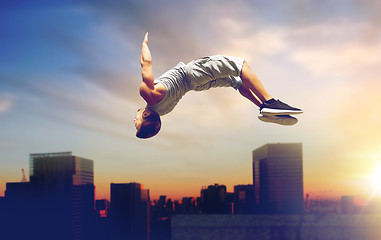 Image showing man making parkour jumping over tokyo city