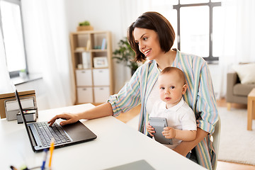 Image showing working mother with baby boy and laptop at home