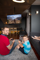 Image showing Happy family playing a motocross video game