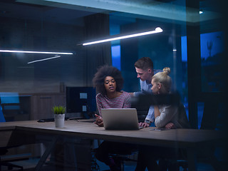 Image showing Multiethnic startup business team in night office