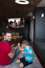 Image showing Happy family playing a video game