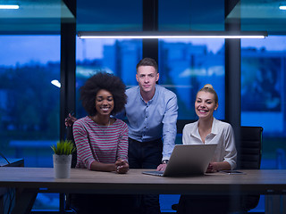 Image showing Multiethnic startup business team in night office