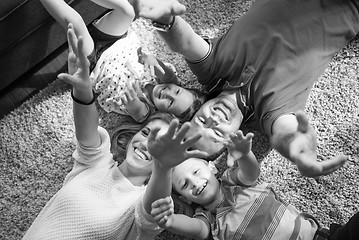 Image showing happy family lying on the floor