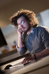 Image showing man working on computer in dark office